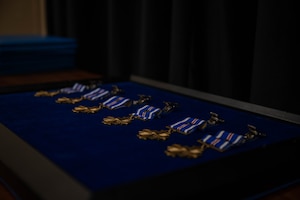 LANGLEY AIR FORCE BASE, Va – Distinguished Flying Cross medals with the “C” device wait to be presented during a Distinguished Flying Cross ceremony at Langley Air Force Base, Virginia, Aug. 31, 2026. The DFC medal with the “C” device is awarded to Airmen who were exposed to hostile action and had shown heroism or extraordinary achievement while participating in aerial flight. (U.S. Air Force photo by Airman 1st Class Kaden Ciminnisi)