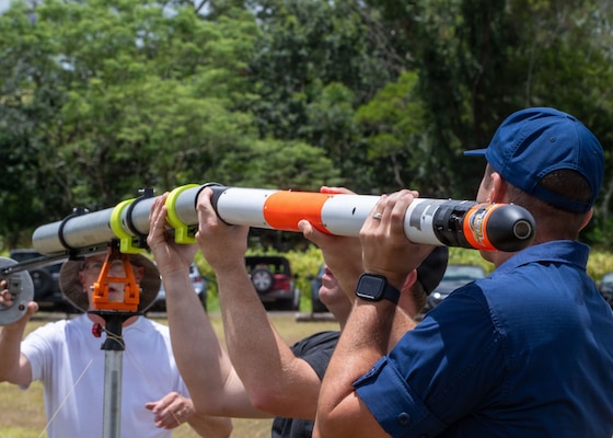 Naval Postgraduate School (NPS) researchers exploring applications of advanced manufacturing for low-cost missile design prepare an experimental rocket for launch during RIMPAC 2026, July 7. Over the course of the large, multinational exercise, a total of 20 NPS students, faculty and researchers took their graduate studies and thesis research out of the classroom and into the operational environment, advancing their work alongside the fleet and participating industry partners. (U.S. Navy photo by Mass Communication Specialist Seaman Katherine Eldridge)