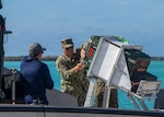 Naval Postgraduate School (NPS) student U.S. Navy Lt. Evan Humphreys prepares cargo for transit via an unmanned surface vessel during RIMPAC 2026, July 7. A mechanical engineering student, Humphreys' participation supported his research in advanced manufacturing and autonomous logistics, coordinating operations between the NPS team and multiple ships while working alongside operators and industry partners. (U.S. Navy photo by Mass Communication Specialist Seaman Katherine Eldridge)