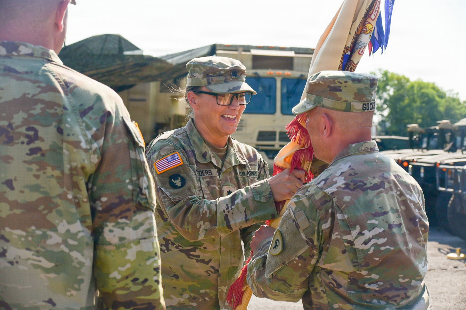 U.S. Army Lt. Col. Dayna Sanders, outgoing commander of the 103rd Brigade Support Battalion, passes the battalion colors to Col. Jonathan Gocke, commander of the 38th Infantry Division Artillery, during a change of command ceremony at the 103rd BSB armory in Harrodsburg, Kentucky, Aug. 9, 2026.