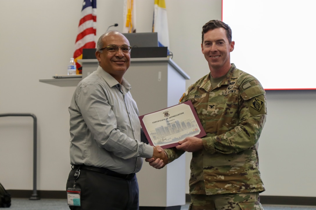 (from left) Michael Fam, San Bernardino engineering manager and Col. Joshua Bost, USACE LA District commander pose for an award ceremony recognizing Fam for his efforts in making the Aug. 20 Tabletop Exercise possible in San Bernardino, California.
