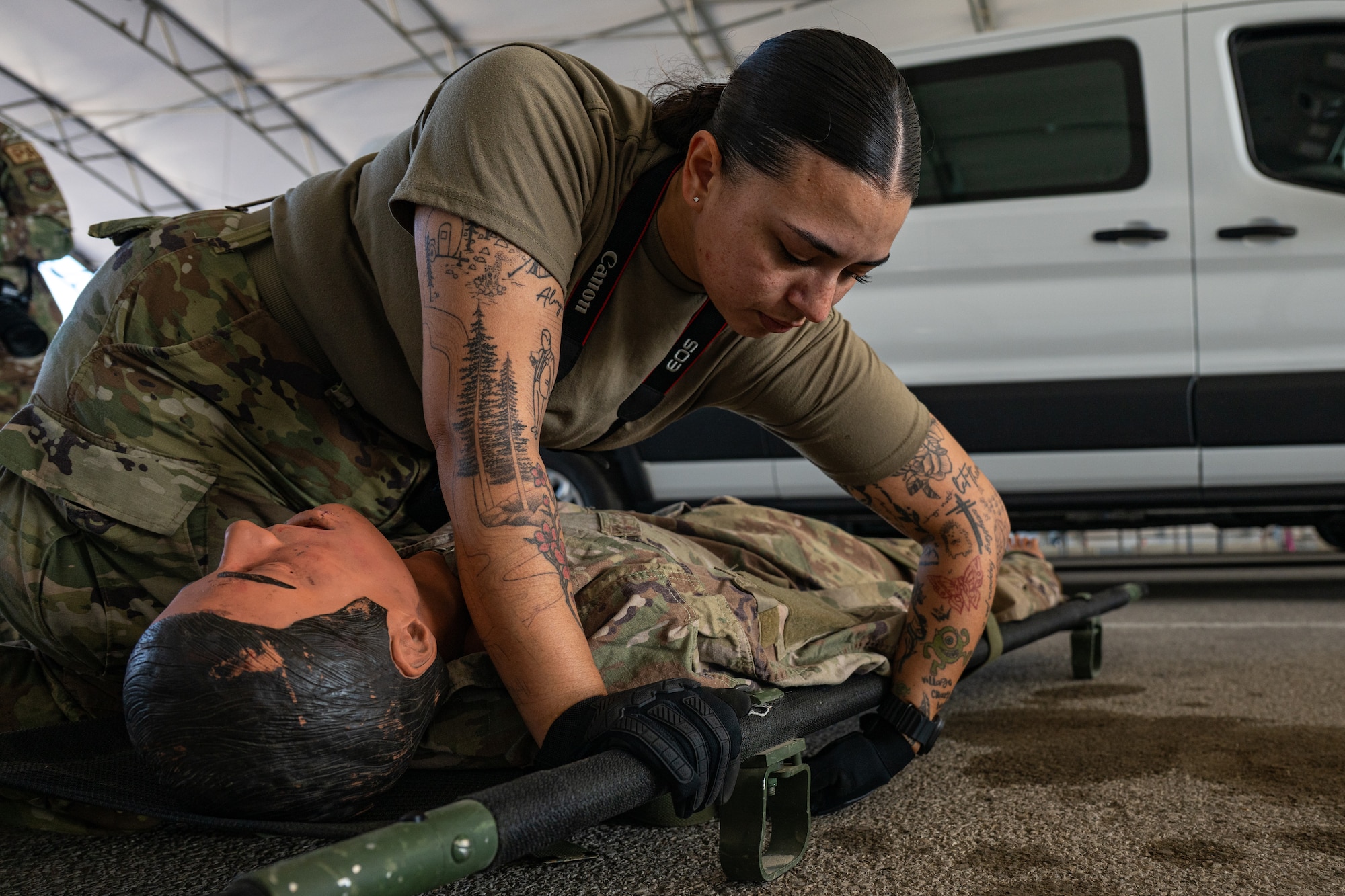 U.S. Army Pfc. Julie Gonzales secures a simulated patient to a litter while verifying equipment at Scott Air Force Base, Illinois, in support of Exercise Ultimate Caduceus 2026.