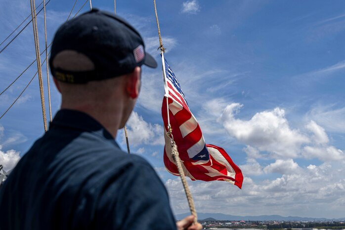U.S. Navy Quartermaster 1st Class Landon Sherrill shifts colors aboard Nimitz-class aircraft carrier USS Abraham Lincoln (CVN 72), as Abraham Lincoln departs Laem, Chabang, Thailand on Sept. 6, 2026.