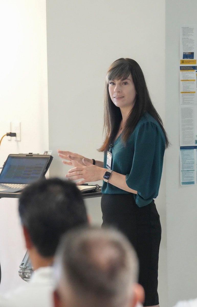 woman standing speaking to a group