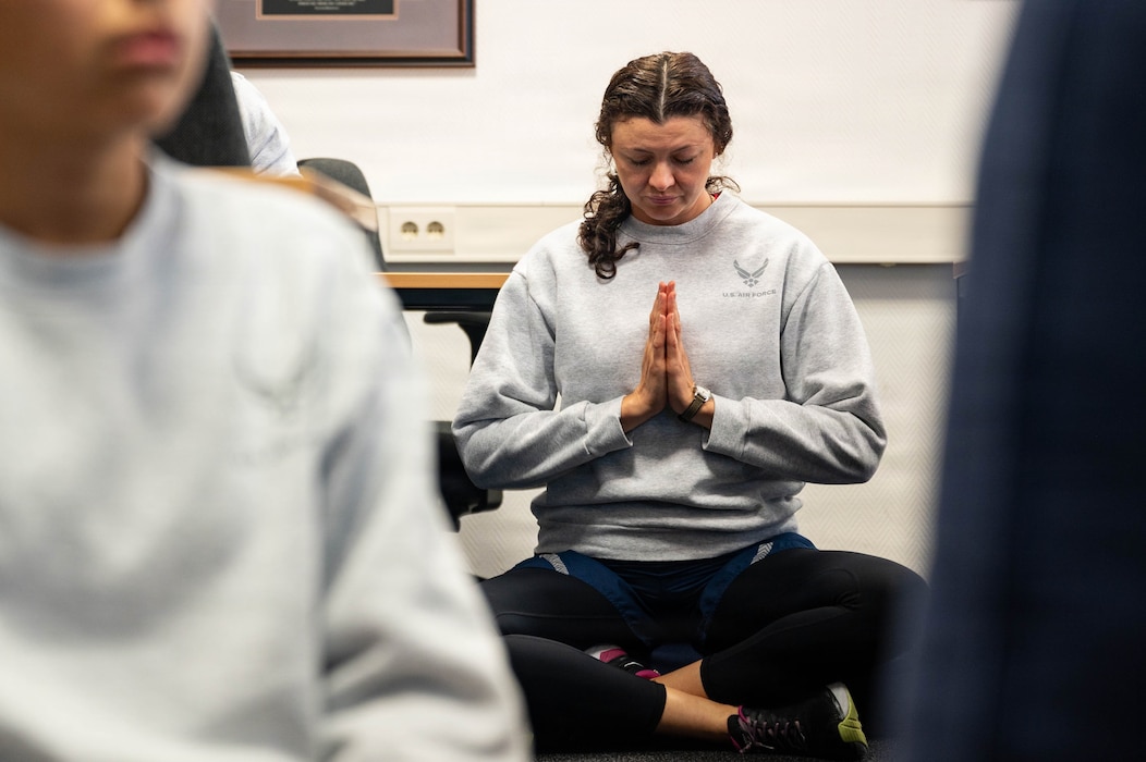 A U.S. Air Force Airman meditates during an Introduction to Meditation class during Saber Fitness Day.