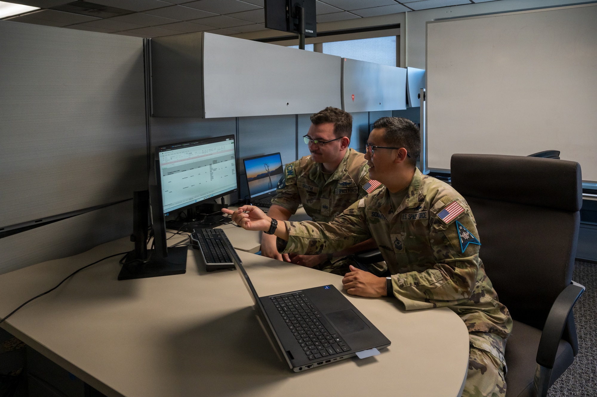 Guardians in uniform working at computers indoors