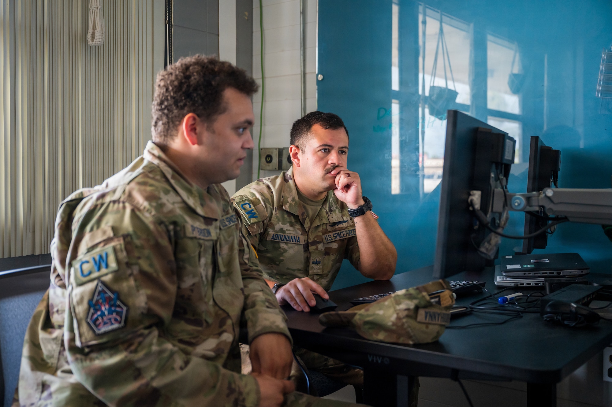 Guardians in uniform working at computers indoors