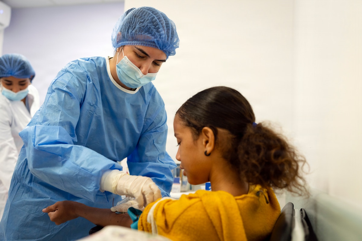 U.S. Air Force Senior Airman Raquel Kos, medical technician supporting Amistad 2026, collects a blood sample from a patient at Hospital Municipal Dra. Armida García in La Vega, Dominican Republic, Aug. 6, 2026. Working within a partner-nation healthcare facility gave Airmen real-world experience providing care in an unfamiliar clinical environment. (U.S. Air Force photo by Tech. Sgt. Rachel Maxwell)