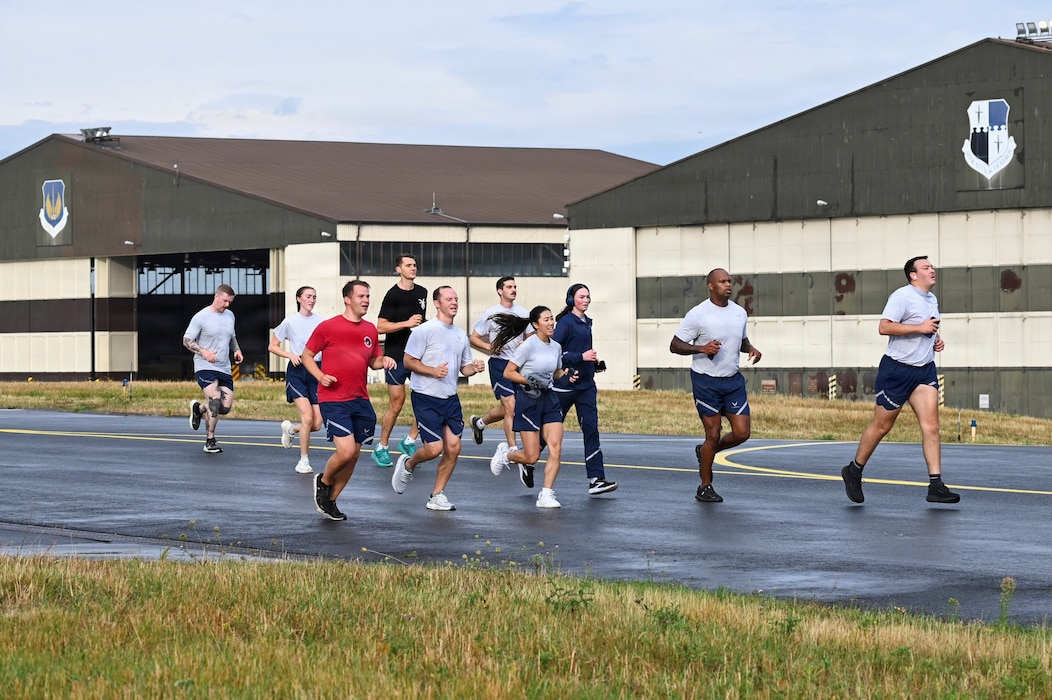 U.S. Airmen assigned to the 52nd Fighter Wing run on the flight line during Saber Fitness Day.