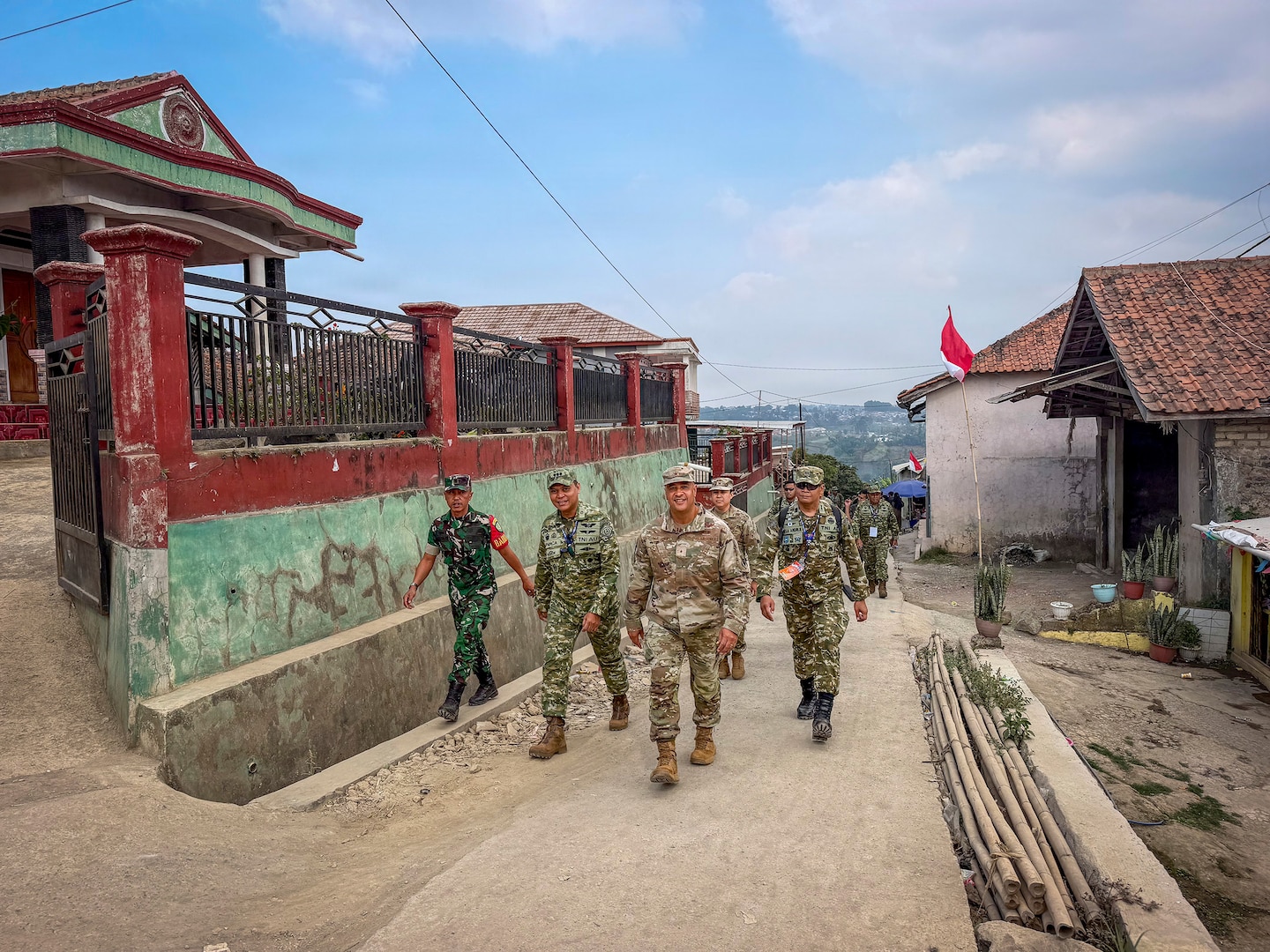 U.S. Air Force Brig. Gen. Phillip L. Mallory, commander of the Hawaii Air National Guard, and multinational service members walk through Pasirlangu Village in the mountainous Cisarua District near Bandung, Indonesia, Sept. 3, 2026, while conducting a site survey of an area affected by a January 2026 landslide.