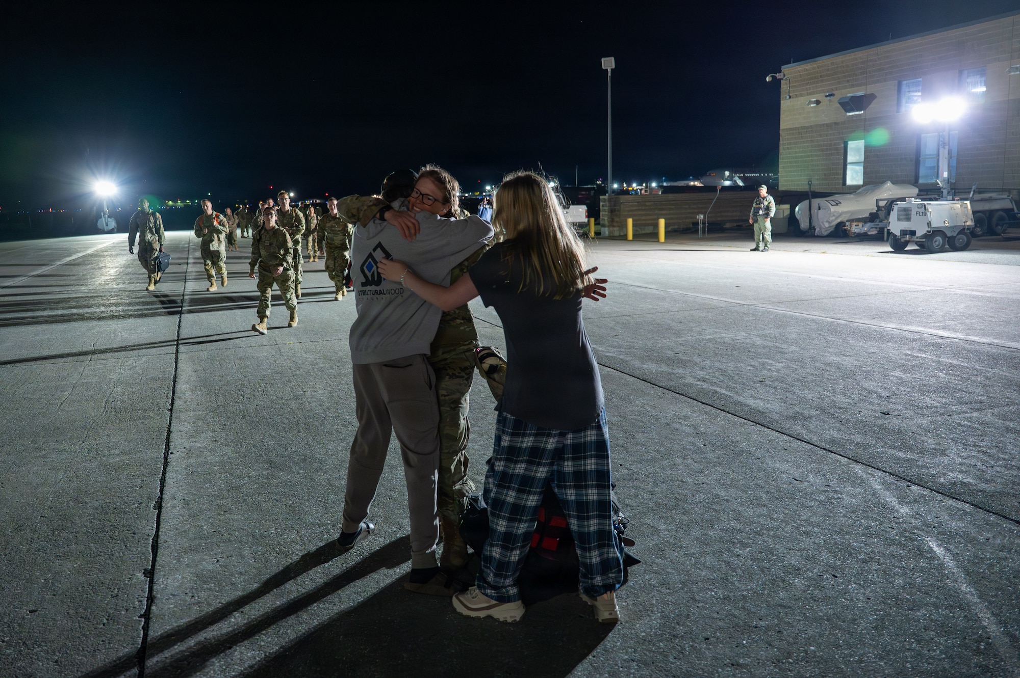 A photo of U.S. Air Force Airmen assigned to the 158th Fighter Wing return from an overseas deployment, arriving back to the Vermont Air National Guard, South Burlington.