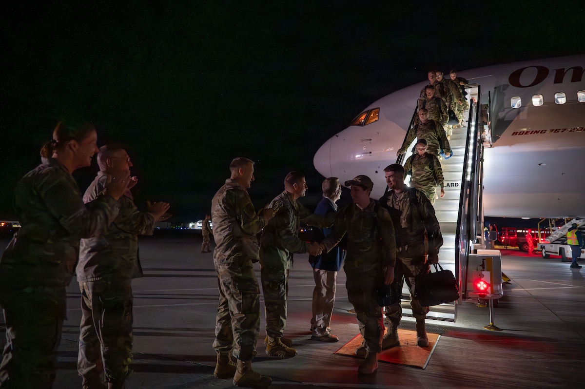 A photo of U.S. Air Force Airmen assigned to the 158th Fighter Wing return from an overseas deployment, arriving back to the Vermont Air National Guard, South Burlington.