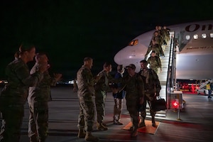 A photo of U.S. Air Force Airmen assigned to the 158th Fighter Wing return from an overseas deployment, arriving back to the Vermont Air National Guard, South Burlington.