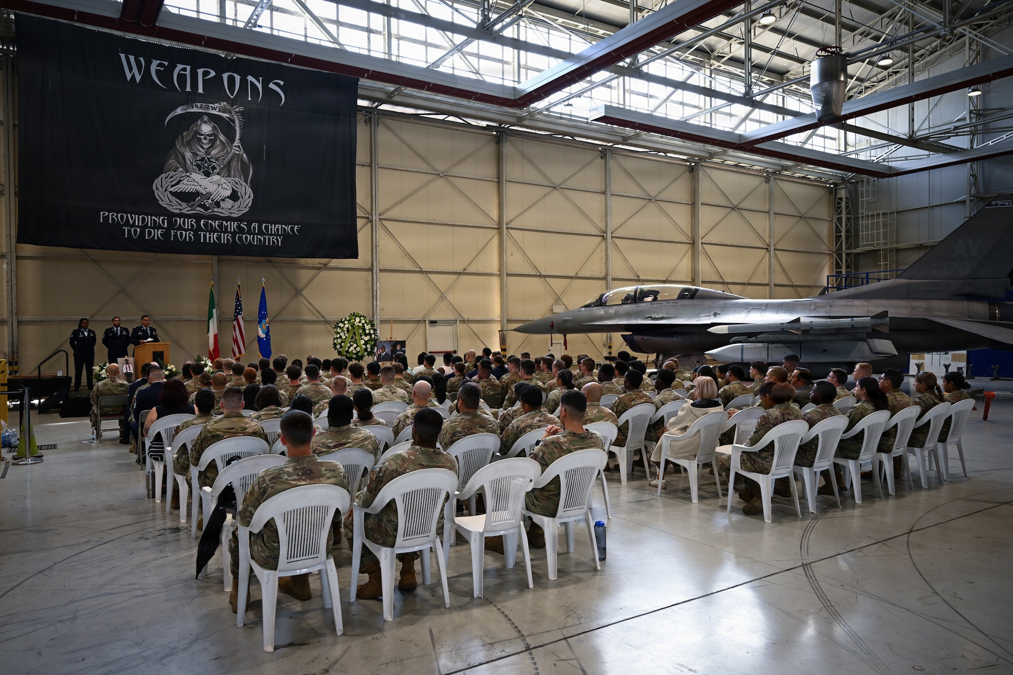 Airmen sit together in a large group.