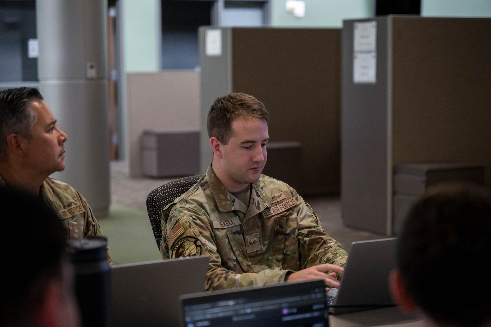 Kansas National Guard cyber specialists work alongside state and federal partners to monitor networks and analyze potential cyber threats during a state active duty mission in support of the FIFA World Cup at the Heartland Preparedness Center in Wichita, Kan. on July 15, 2026. The joint task force, consisting of Kansas Army and Air National Guardsmen, provides critical infrastructure defense, threat hunting, and incident response capabilities to ensure the security of state and local entities.(U.S. Air National Guard Photo by 1st Lt. Samantha Root)
