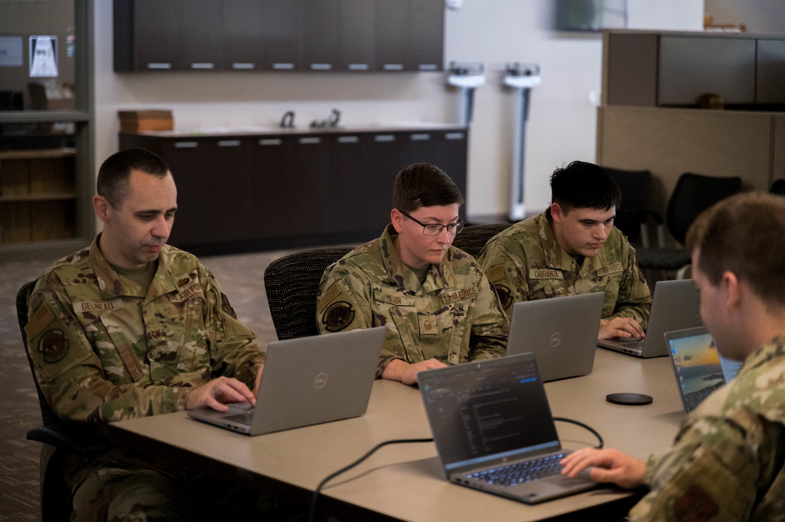 Kansas National Guard cyber specialists work alongside state and federal partners to monitor networks and analyze potential cyber threats during a state active duty mission in support of the FIFA World Cup at the Heartland Preparedness Center in Wichita, Kan. on July 15, 2026. The joint task force, consisting of Kansas Army and Air National Guardsmen, provides critical infrastructure defense, threat hunting, and incident response capabilities to ensure the security of state and local entities.(U.S. Air National Guard Photo by 1st Lt. Samantha Root)