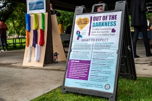 An Out of the Darkness event sign displays information about the one and a half mile walk and suicide prevention safety expo at Fairchild Air Force Base, Washington, Sept. 8, 2026.