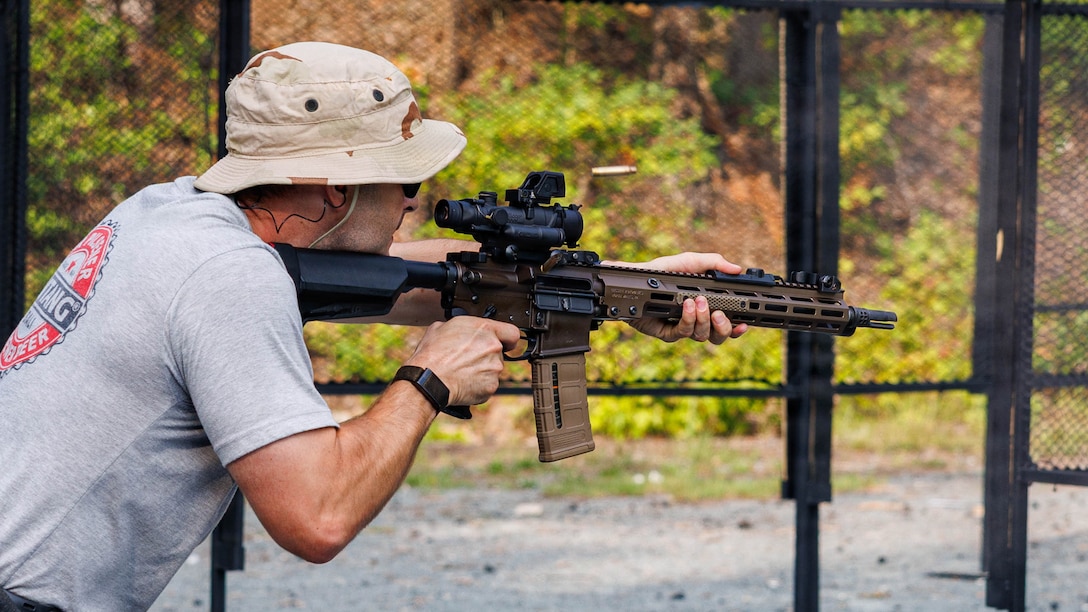 A competitor completes a course of fire during the two-gun match at the Ironman Range on Marine Corps Base Quantico, Virginia, Aug. 15, 2026. The Quantico Shooting Club partnered with the Marine Corps Gunner Association to host the second annual two-gun match. (U.S. Marine Corps photo by Lance Cpl. Donovan E. Melendez)