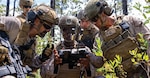 U.S. Marine Corps Sgt. Idris Idris, center, a small unmanned aircraft systems specialist with U.S. Marines with 1st Battalion, 2nd Marine Regiment, 2nd Marine Division, demonstrates the C100 drone capabilities to a Spanish marine during a company live-fire range as a part of Fleet Exercise 250 (FLEETEX) on Marine Corps Base Camp Lejeune, North Carolina, June 19, 2026.