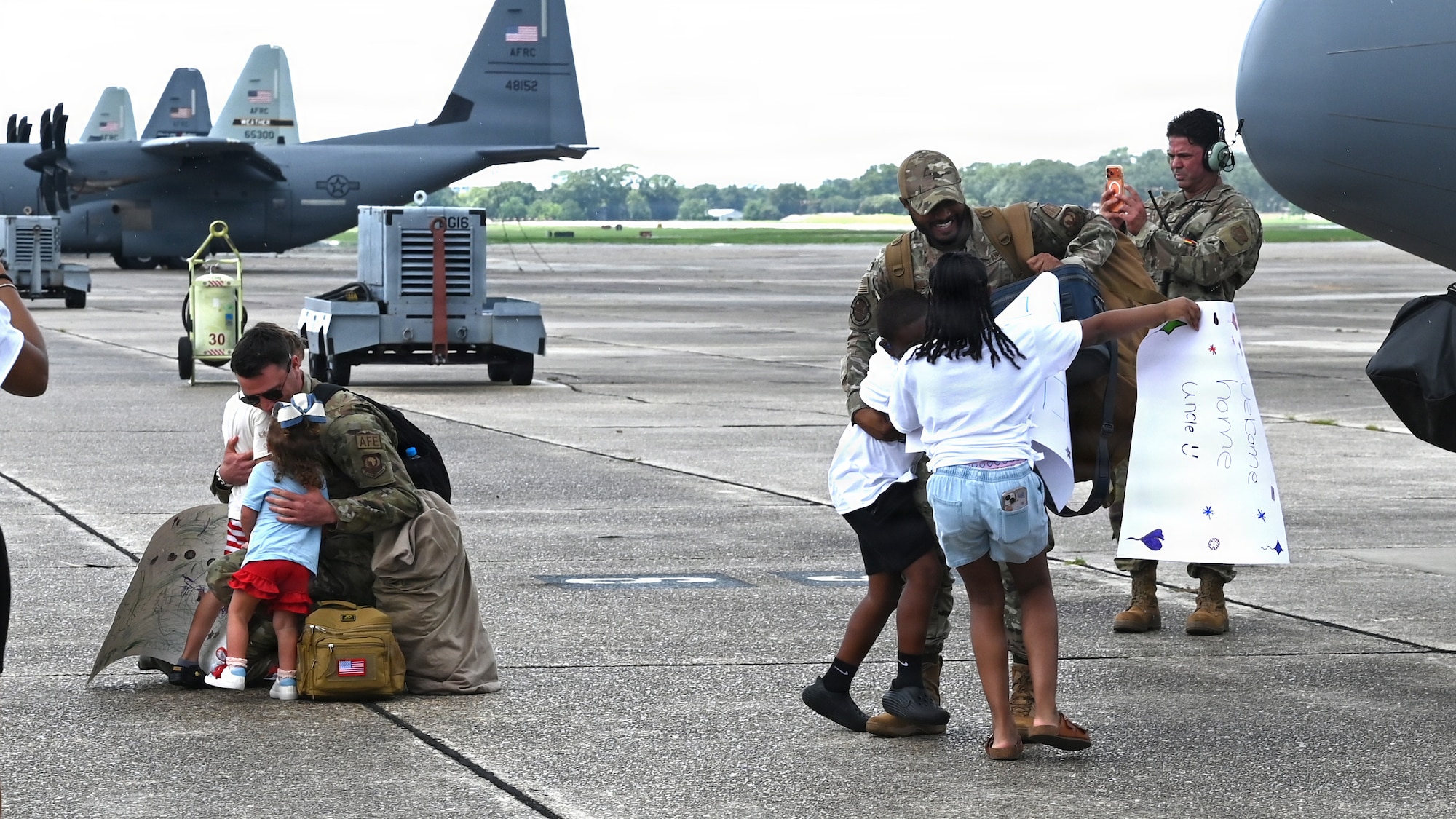 Airmen hug family members after a deployment
