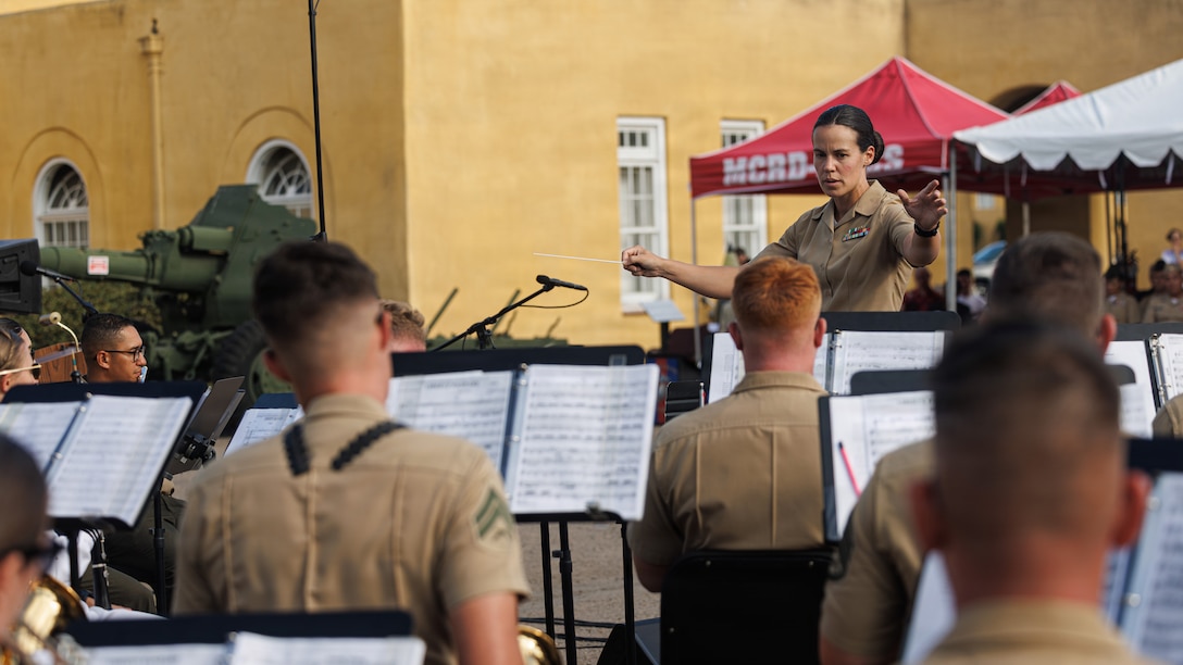 U.S. Marine Corps Staff Sgt. Hannah Ford, an enlisted conductor with Marine Band San Diego, Marine Corps Recruit Depot San Diego and the Western Recruiting Region, conducts the band during the annual Summer Concert performance at MCRD San Diego, California, Aug. 12, 2026. MCRD San Diego hosted its annual Summer Concert and Commanding General’s Reception, inviting permanent personnel, dependents, visitors and distinguished guests to enjoy a musical performance, build camaraderie and celebrate the summer season. (U.S. Marine Corps photo by Lance Cpl. Kevin Alonso)