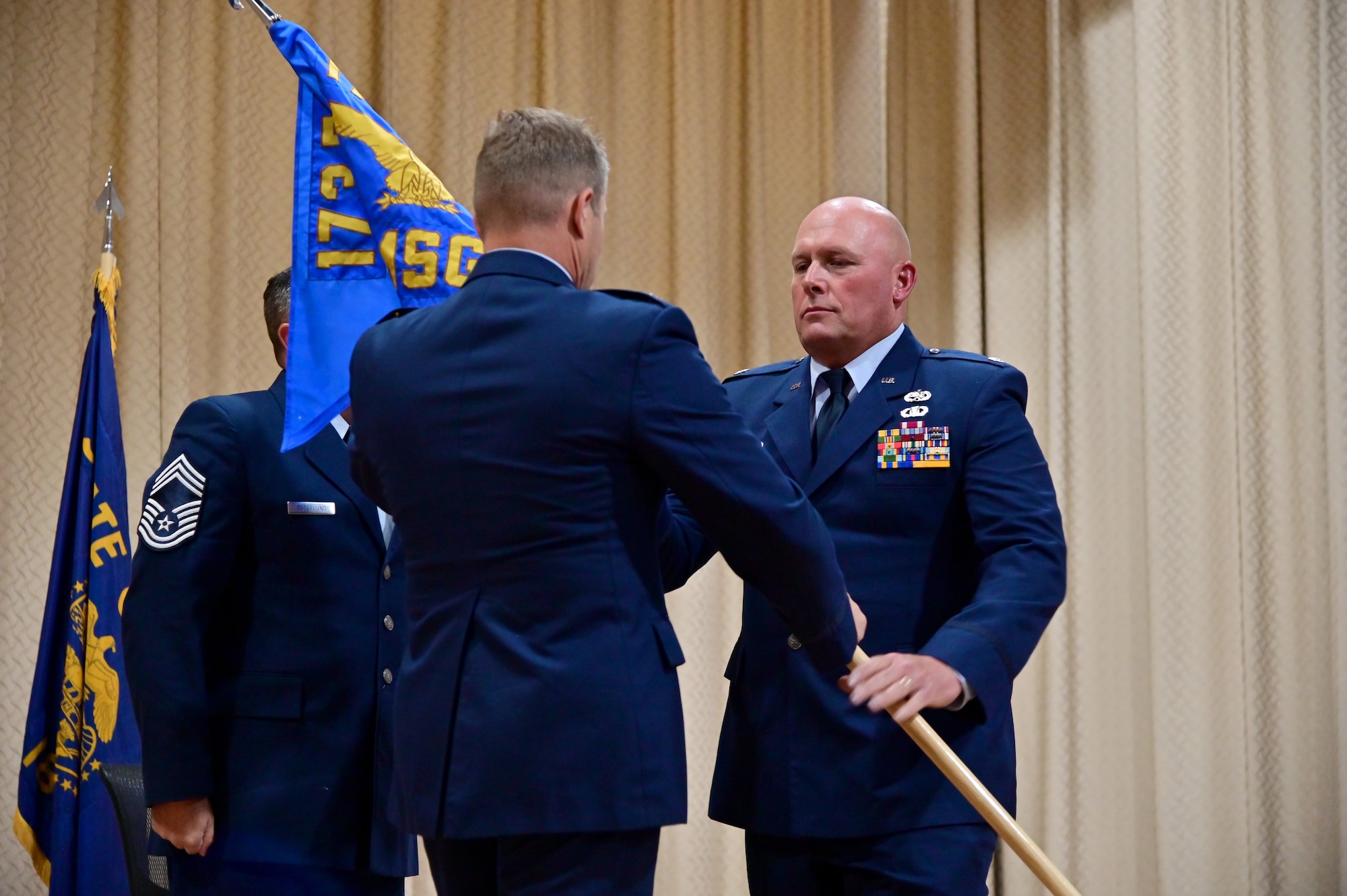 two people hold a flag