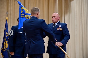 two people hold a flag