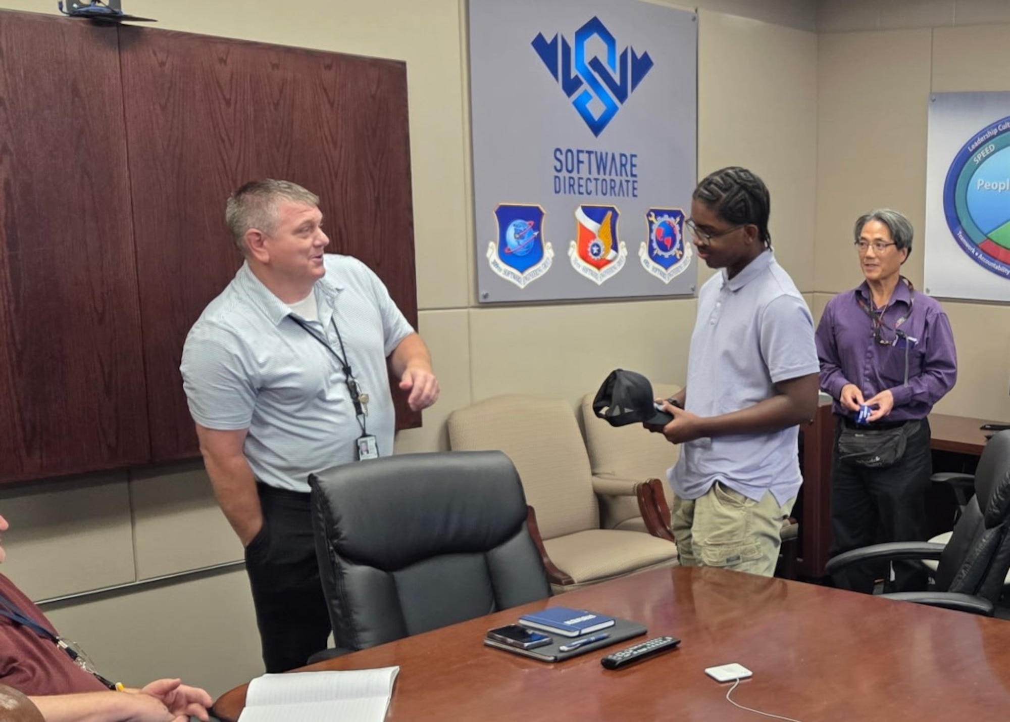 A man receives a commemorative coin.