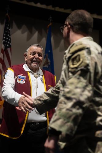 Retired U.S. Air Force Capt. Bill Robinson shakes hands with an Airman at Joint Base Elmendorf-Richardson, Alaska, Sept. 8, 2026. Robinson visited JBER to share his experiences as a prisoner of war and speak to service members about resilience and military heritage. (U.S. Air Force photo by Airman 1st Class Theodore Gowdy)
