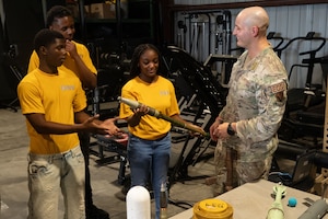 Airman shows students military tools