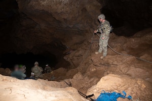 U.S> Air Force Pararescuemen assigned to the 68th Rescue Squadron perform a cave rescue during an exercise at a local cave, Arizona, August 20, 2026. The Pararescuemen participated in the Combat Leader Course, an intensive training event designed to teach Pararescuemen advanced rescue and leadership skills. (U.S. Air Force photo by Airman 1st Class Jaden Kidd)

Photo edited for security purposes.