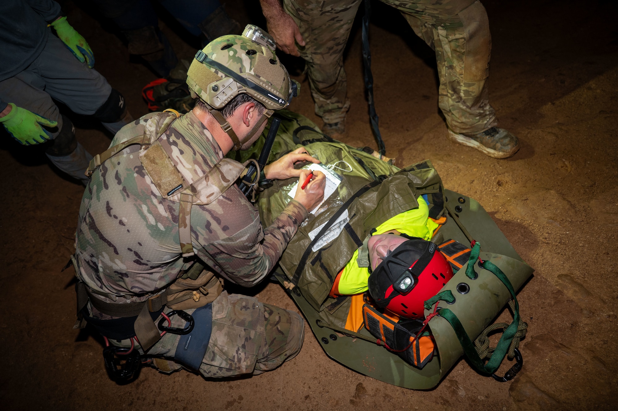 U.S. Air Force Pararescuemen assigned to the 68th Rescue Squadron check the vitals of a simulated casualty during an exercise at a local cave, Arizona, August 20, 2026. The Pararescuemen participated in the Combat Leader Course, which trains Airmen in advanced rescue techniques and mission leadership. (U.S. Air Force photo by Airman 1st Class Jaden Kidd)