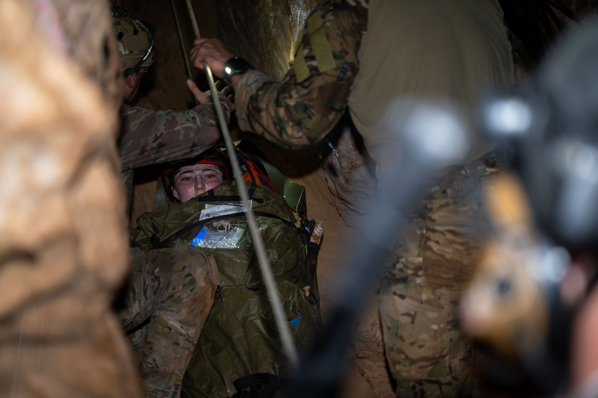 U.S. Air Force Pararescuemen assigned to the 68th Rescue Squadron transport a simulated casualty during the Combat Leader Course at a local cave, Arizona, August 20, 2026. CLC uses realistic, high-pressure scenarios to prepare Pararescuemen to respond decisively during rescue operations. (U.S. Air Force photo by Airman 1st Class Jaden Kidd)