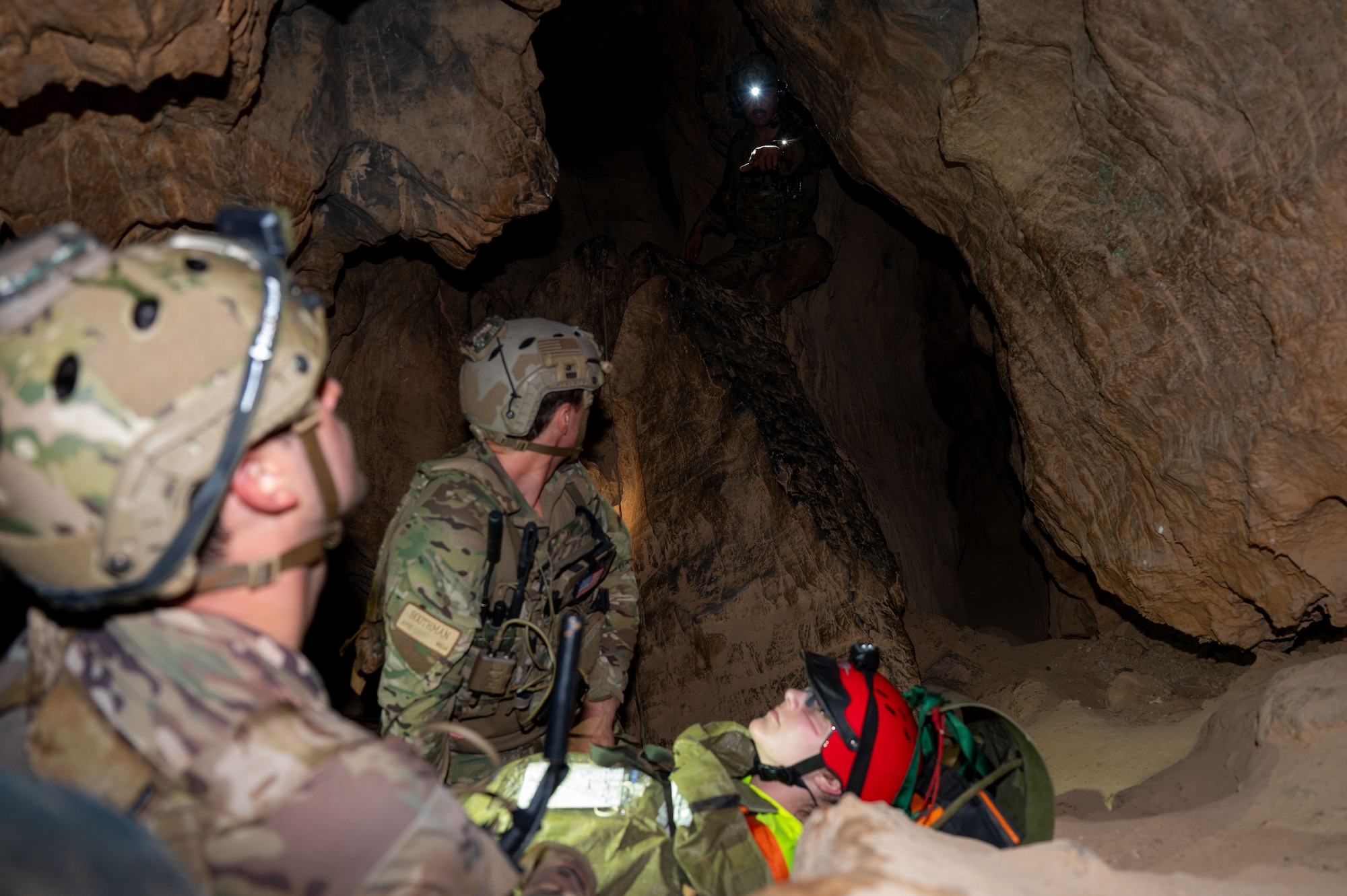 U.S. Air Force Pararescuemen assigned to the 68th Rescue Squadron strategize simulated casualty movement during an exercise at a local cave, Arizona, August 20, 2026. The exercise tasked Pararescuemen with rescuing a simulated casualty while safely moving through an austere environment. (U.S. Air Force photo by Airman 1st Class Jaden Kidd)