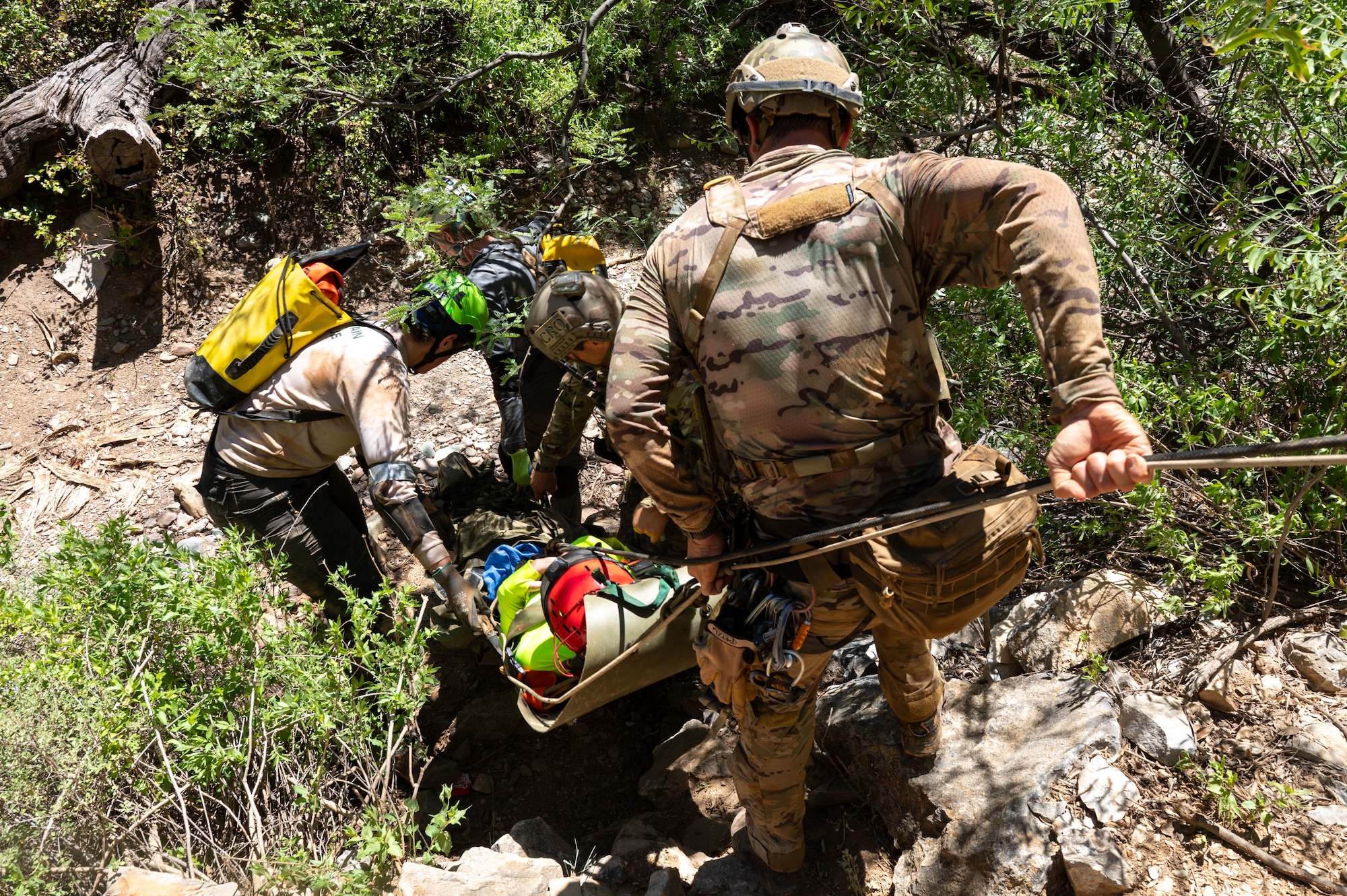 U.S. Air Force Pararescuemen assigned to the 68th Rescue Squadron move a simulated casualty during an exercise at a local cave, Arizona, August 20, 2026. The Pararescuemen participated in the Combat Leader Course, which trains Airmen in advanced rescue techniques and mission leadership. (U.S. Air Force photo by Airman 1st Class Jaden Kidd)