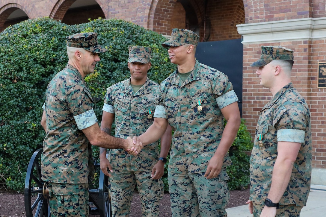 U.S. Marine Corps Col. Jason Copeland, commanding officer, Marine Barracks Washington, congratulates Cpl. Alexander Wilson, a White House sentry with Guard Company, Marine Barracks Washington, following an awards ceremony at Marine Barracks Washington, D.C., Sept 9, 2026. Five White House sentries assigned to Guard Company, Marine Barracks Washington, received Navy and Marine Corps Achievement Medals for their professionalism, vigilance and resilience while serving as White House sentries during Operation Midnight Hammer and Operation Absolute Resolve from June 2025 to March 2026. Whether safeguarding the “Oldest Post of the Corps” or standing watch in direct support of the President, Barracks Marines demonstrate the discipline and resilience required to respond when and where they are needed. (U.S. Marine Corps photo by Capt. Lauri Schleicher)