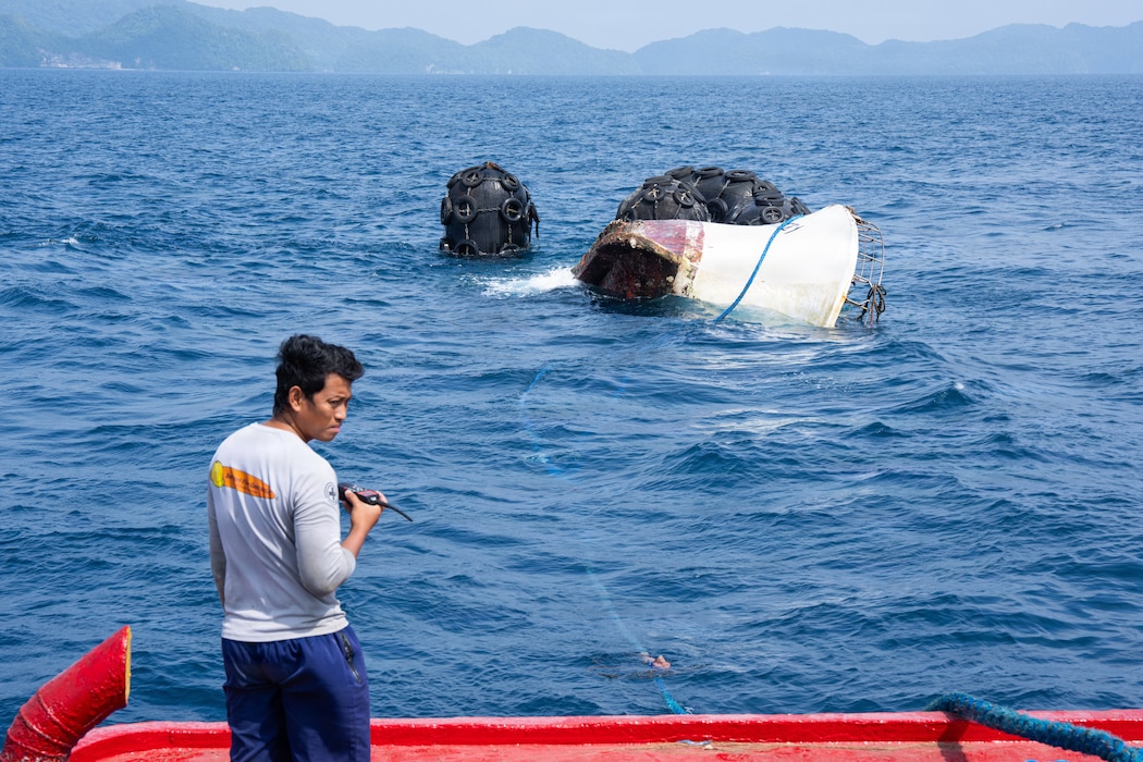 A Palaun civilian mariner aboard the tug boat SSC Tanchall monitors the list and trim of the abandoned derelict vessel “Justice 1” while it is towed out to sea during a Pacific Partnership 2026 salvage operation in Koror, Palau, Aug. 30, 2026.