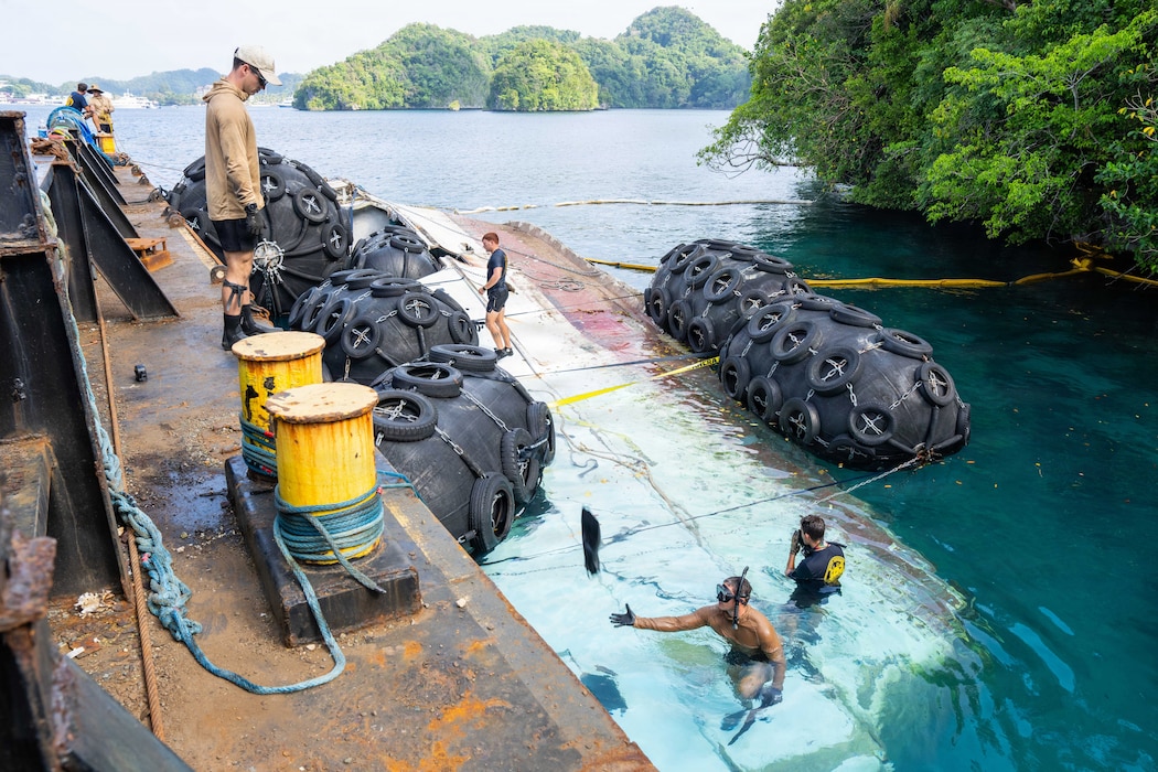 Navy Divers, assigned to Explosive Ordnance Disposal Mobile Unit (EODMU) 9, prepare to remove the abandoned derelict vessel “Justice 1” from Koror, Palau, during a Pacific Partnership 2026 salvage operation, Aug. 29, 2026.