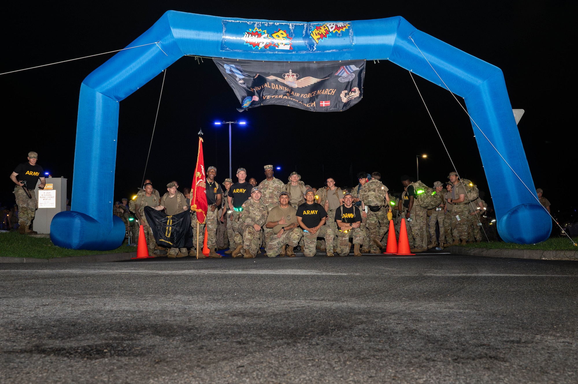 U.S. service members and civilians pose for a photo before beginning the Royal Danish Air Force Flyver March at Kadena Air Base, Japan, Aug. 29, 2026. The Flyver March traces its roots to the Royal Danish Air Force and has become a military endurance event centered on completing a ruck march with a weighted pack. (U.S. Air Force photo by Airman 1st Class Nathaniel Jackson)