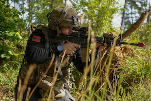 A U.S. Soldier assigned to Joint Multinational Readiness Center's 1st Battalion, 4th Infantry Regiment, known as the opposition forces, at Hohenfels Training Area, engages with the primary training audience during Saber Junction 26, Sep. 3, 2026. 7th Army Training Command provides a unique environment in Europe to develop leaders and formations who are prepared for large-scale combat operations, improving readiness. (U.S. Army photo by Pfc. Jermyiah Pangelinan)
