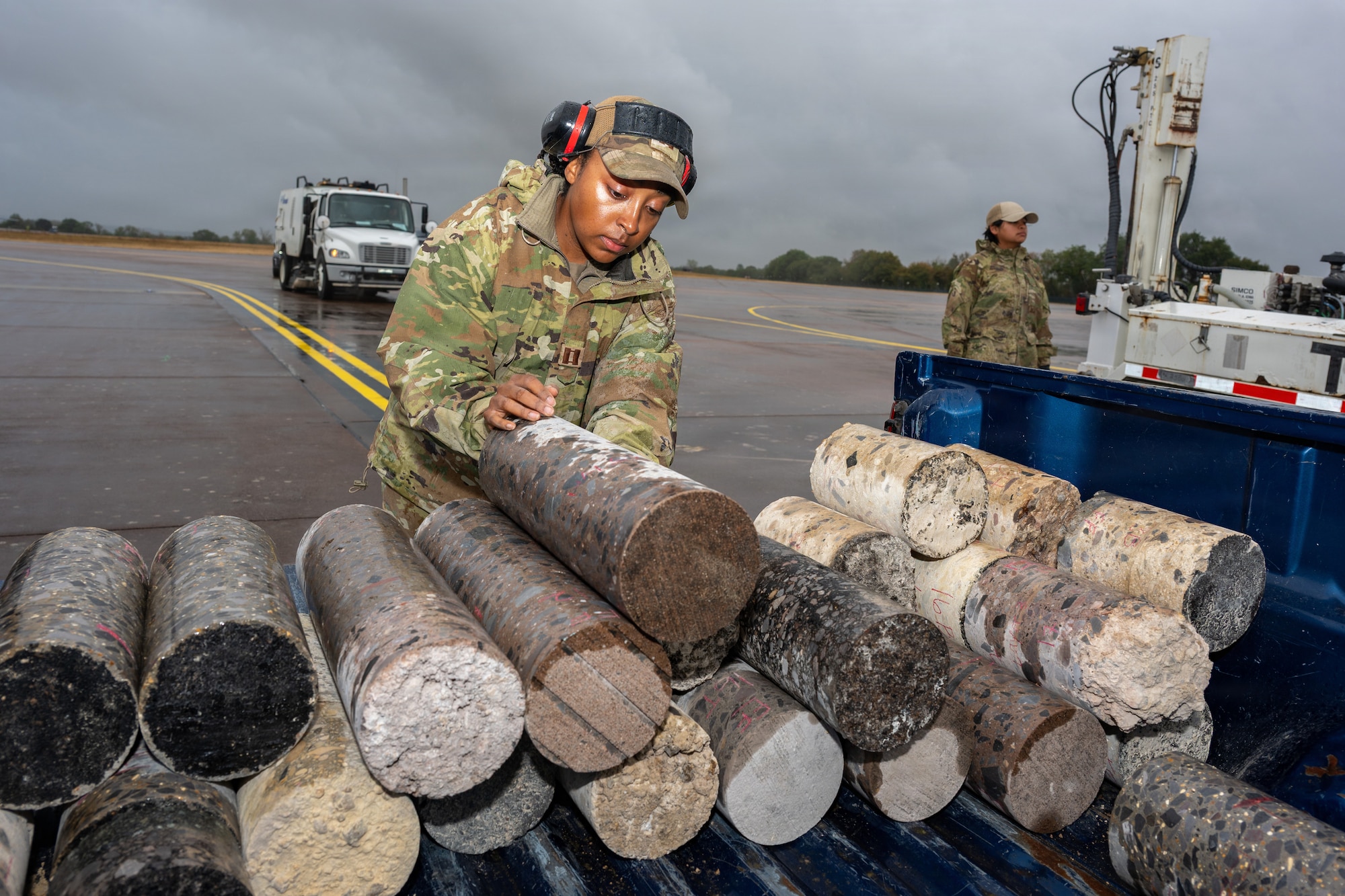 U.S. Air Force Capt. Andi Brown, Air Force Civil Engineer Center Airfield Pavement Evaluation Team officer, stacks pavement cores