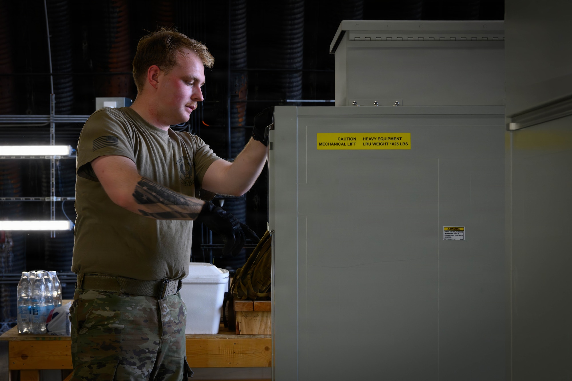 A U.S. Air Force Airman moves equipment off a pallet.