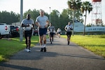 U.S. Air Force Airman 1st Class Jan Mora Rodriguez, center, intel analyst, 125th Operations Support Squadron, 125th Fighter Wing, Florida Air National Guard, runs with student flight members assigned to the 125th Fighter Wing during a fitness assessment at Jacksonville Air National Guard Base, Florida, Aug. 16, 2026. Student flight members conduct a mock physical fitness test while preparing to depart for Basic Military Training, building the readiness, discipline and confidence needed to begin their Air National Guard service. Photo by Tech. Sgt. Marissa Welker.