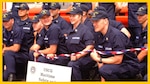 SEATTLE, Wash. (July 3) --- Smiles abound after the commissioning ceremony of the Coast Guard's first Marine Safety and Security Team in Seattle. MSSTs are domestic mobile units that possess specialized training capabilities to perform a wide spectrum of port safety and security operations. They are modeled after the Coast Guard's Port Security Units (PSUs) and Law Enforcement Detachments (LEDETs). MSSTs are being established to protect military load-outs; enforce security zones; defend critical waterside facilities in strategic ports; stop illegal activities, such as narcotics trafficking or illegal migrants; and provide a modest level of shore side protection. USCG photo by PA2 Sarah Foster-Snell