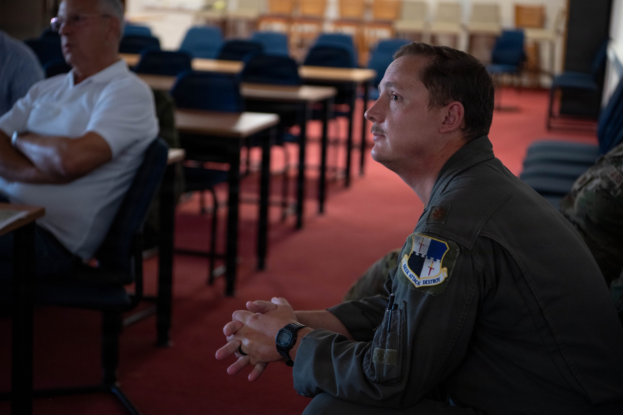 U.S. Air Force Maj. Nick Reisch, a 52nd Fighter Wing safety officer, watches a presentation during the Mid-Air Collision Avoidance Conference.
