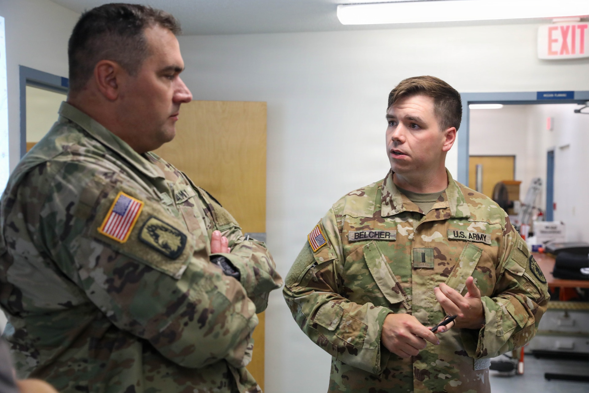 U.S. Army 1st Lt. Matthew Belcher, battle captain with the 751st Troop Command, Kentucky National Guard, discussing the mission details to U.S. Army Lt. Col. Joseph Snoke during Patriot 26at Volk Field Combat Readiness Training Center (CRTC), Wisconsin, Aug. 25, 2026.