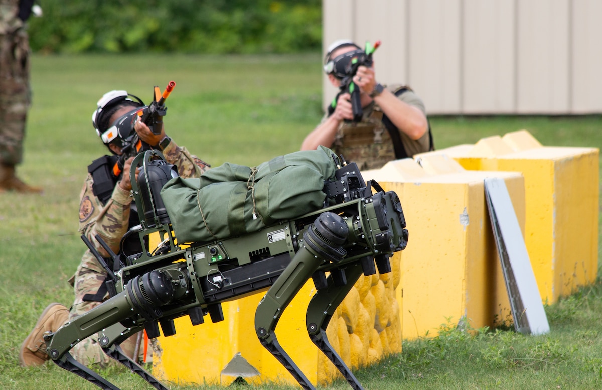 Image of service members training with robotic dog.