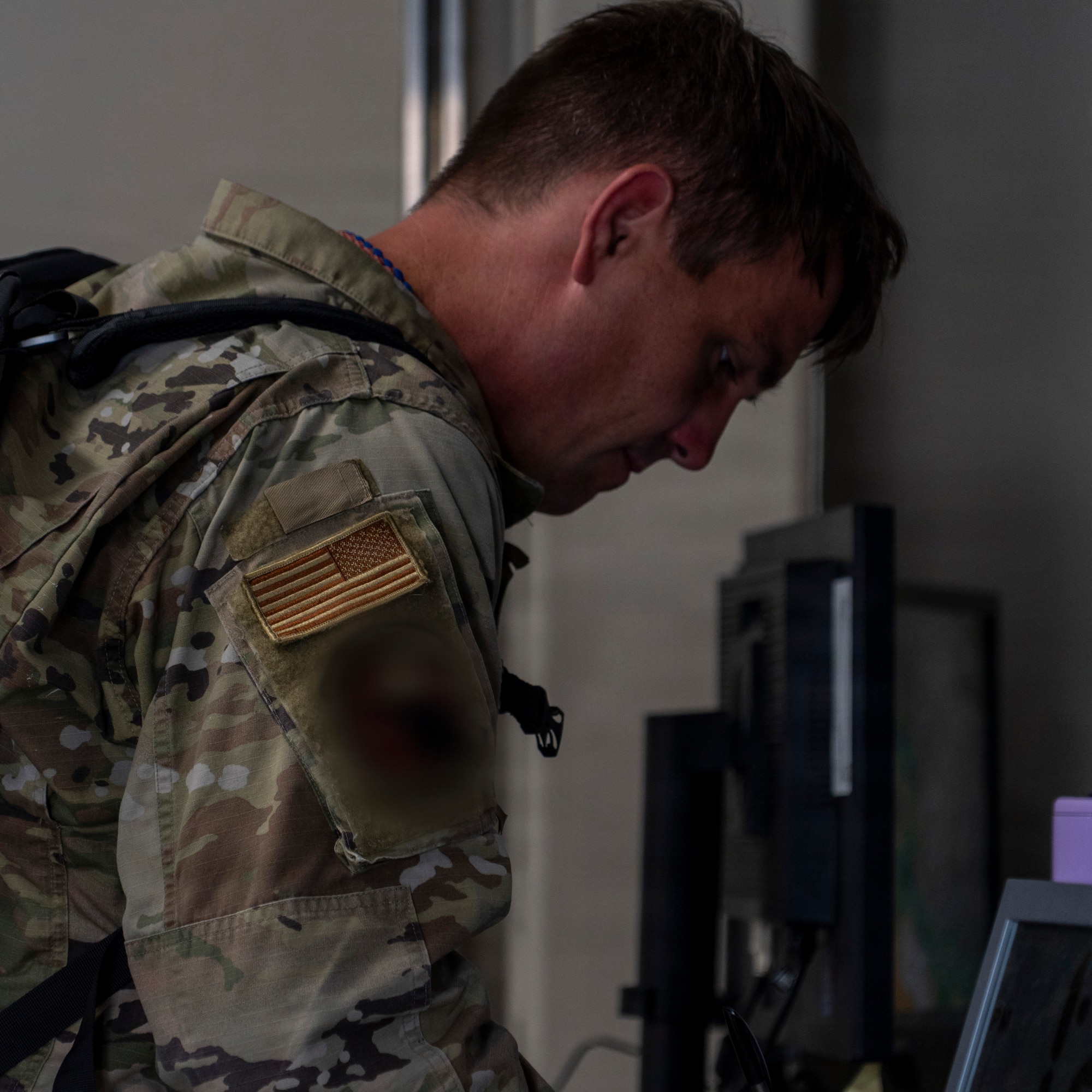 An airman from the 919th Special Operations Wing participates in the Combat Readiness Inspection by passing through a simulated Personnel Deployment Function (PDF) line and receiving mobility gear on August 6 at Duke Field, Fla. The Combat Readiness Inspection was spearheaded by the Air Force Reserve Command Inspector General to evaluate members from the 919th SOW's ability to generate combat power under realistic, high pressure situations in a simulated forward operating location. (U.S. Air Force photo by Senior Airman Emily Bloodworth).