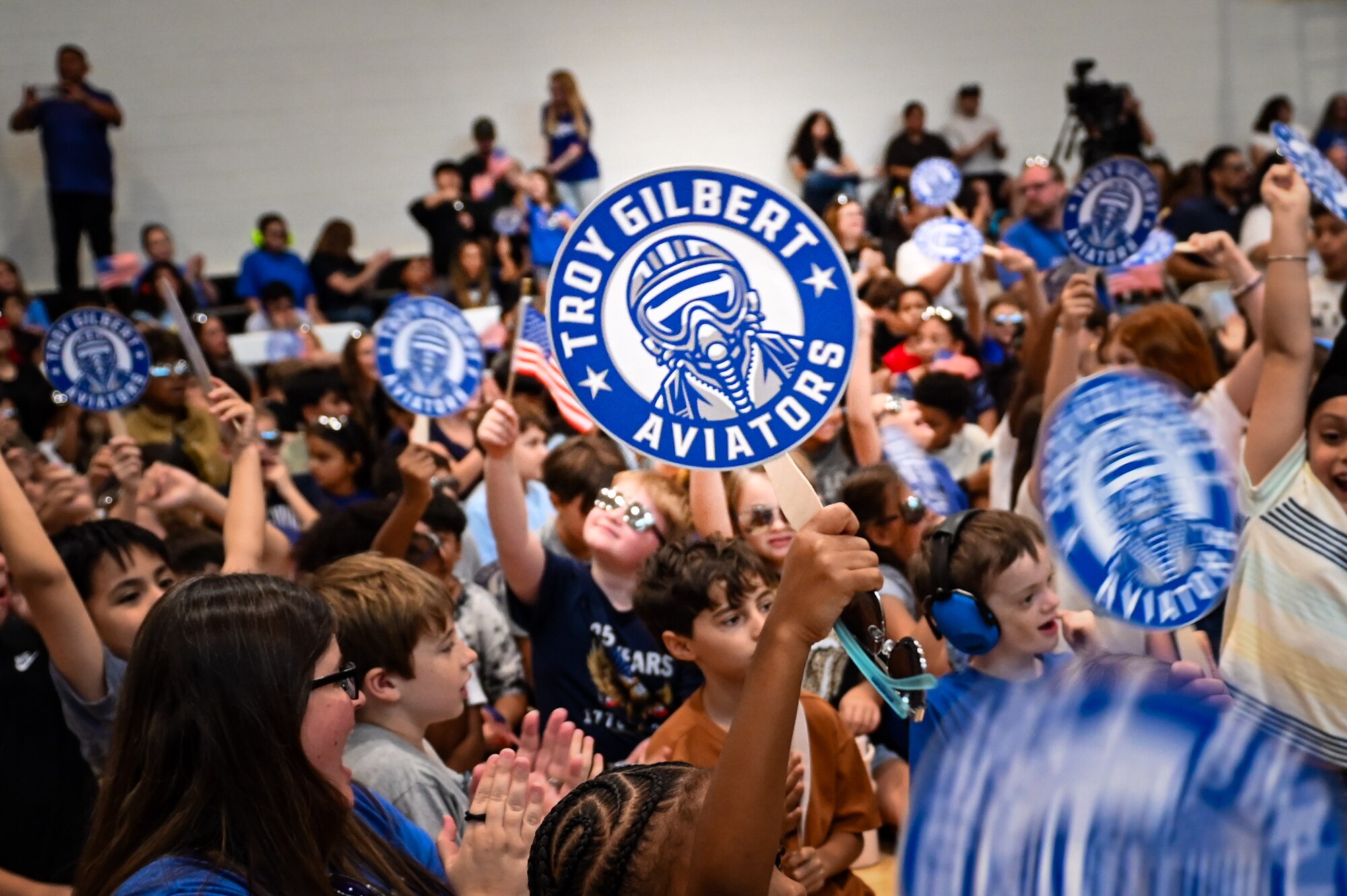 Students at Troy Gilbert Elementary School celebrate during their school’s ribbon-
cutting ceremony in Waddell, Arizona, Aug. 28, 2026. The school selected “Aviators” as
its mascot to honor the aviation heritage of U.S. Air Force Maj. Troy L. Gilbert, inspiring
young students to embody his values of service, character and excellence. (U.S. Air
Force photo by Senior Airman Albert Morel)