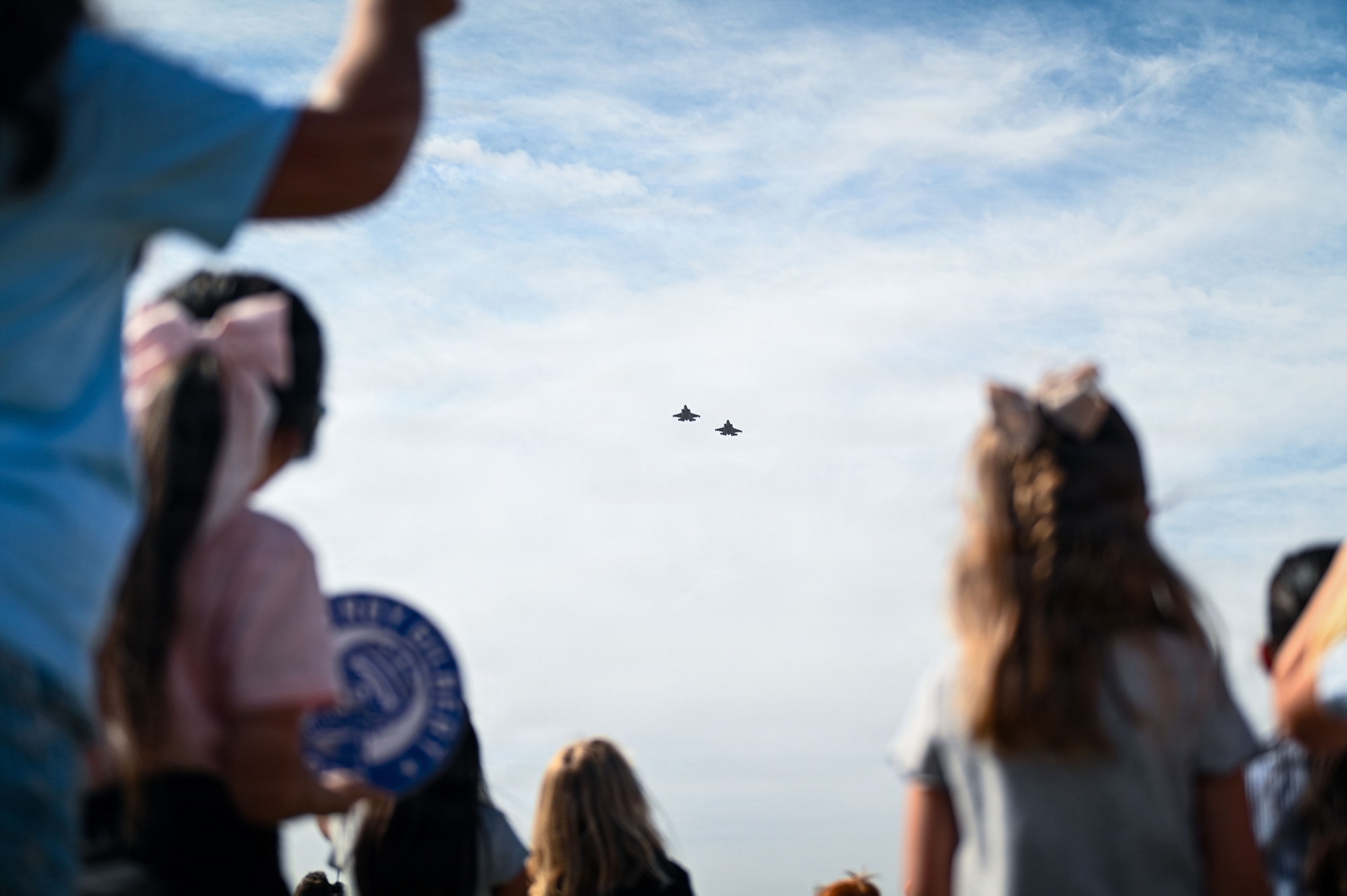 Two U.S. Air Force F-35A Lightning IIs assigned to the 56th Fighter Wing perform a flyover above Troy Gilbert Elementary School during its ribbon-cutting ceremony in Waddell, Arizona, Aug. 28, 2026. The flyover honored the legacy of Maj. Troy L. Gilbert while demonstrating the strong community bond that helps Airmen remain focused on the mission and provides stability for their families. (U.S. Air Force photo by Senior Airman Albert Morel)